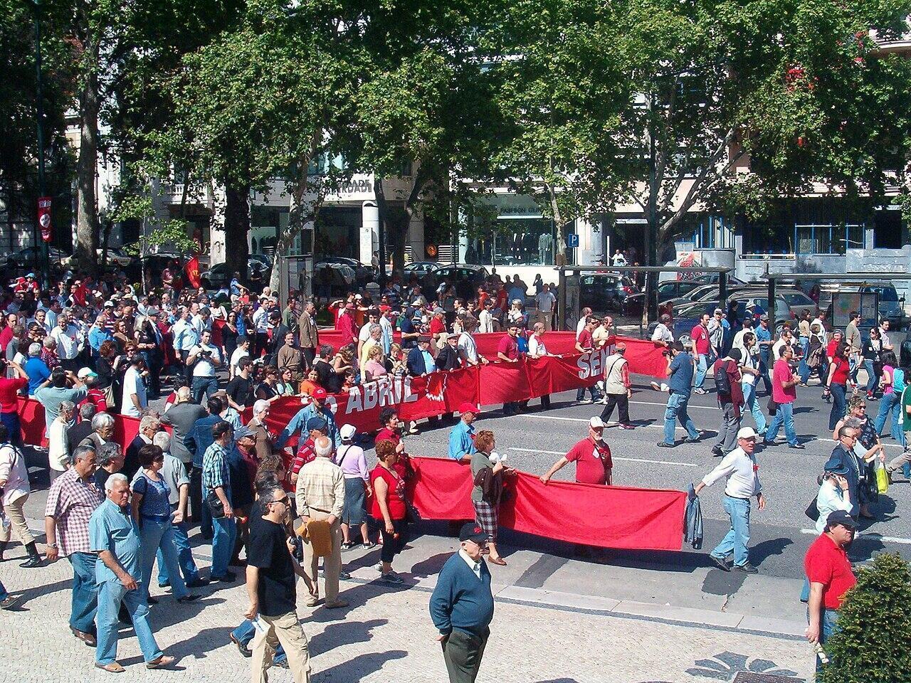 People gathering in Lisbon with red carnations during spring civic celebrations