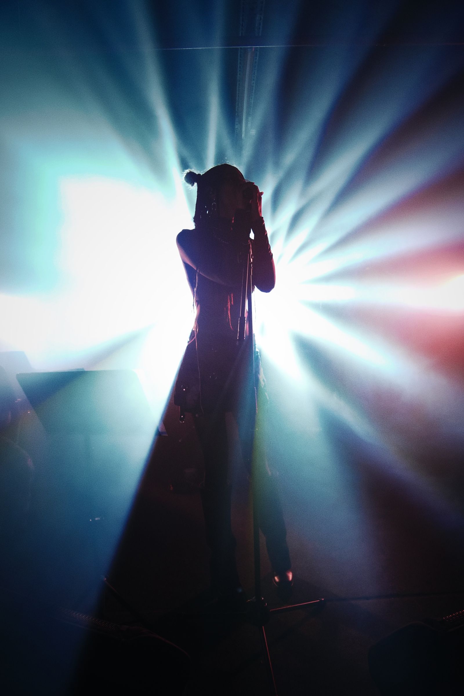 Silhouette of a performer on stage during Céline Dion's Paris residency