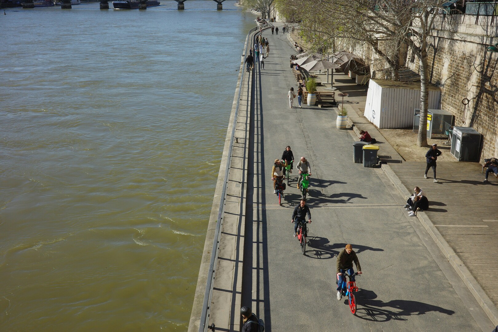 Couples and families walking along the Seine under soft April light