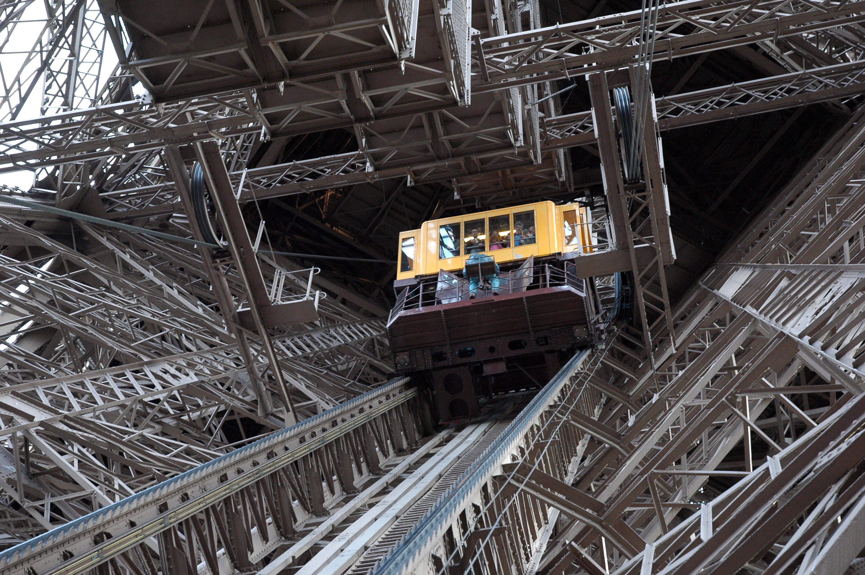 Eiffel Tower elevators and iron lattice structure on a cloudy day in Paris