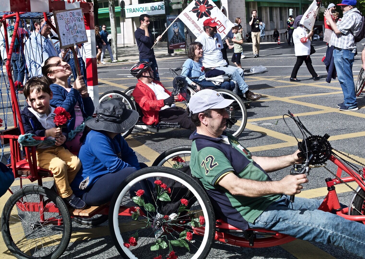 People gathering in Lisbon with red carnations during spring civic celebrations
