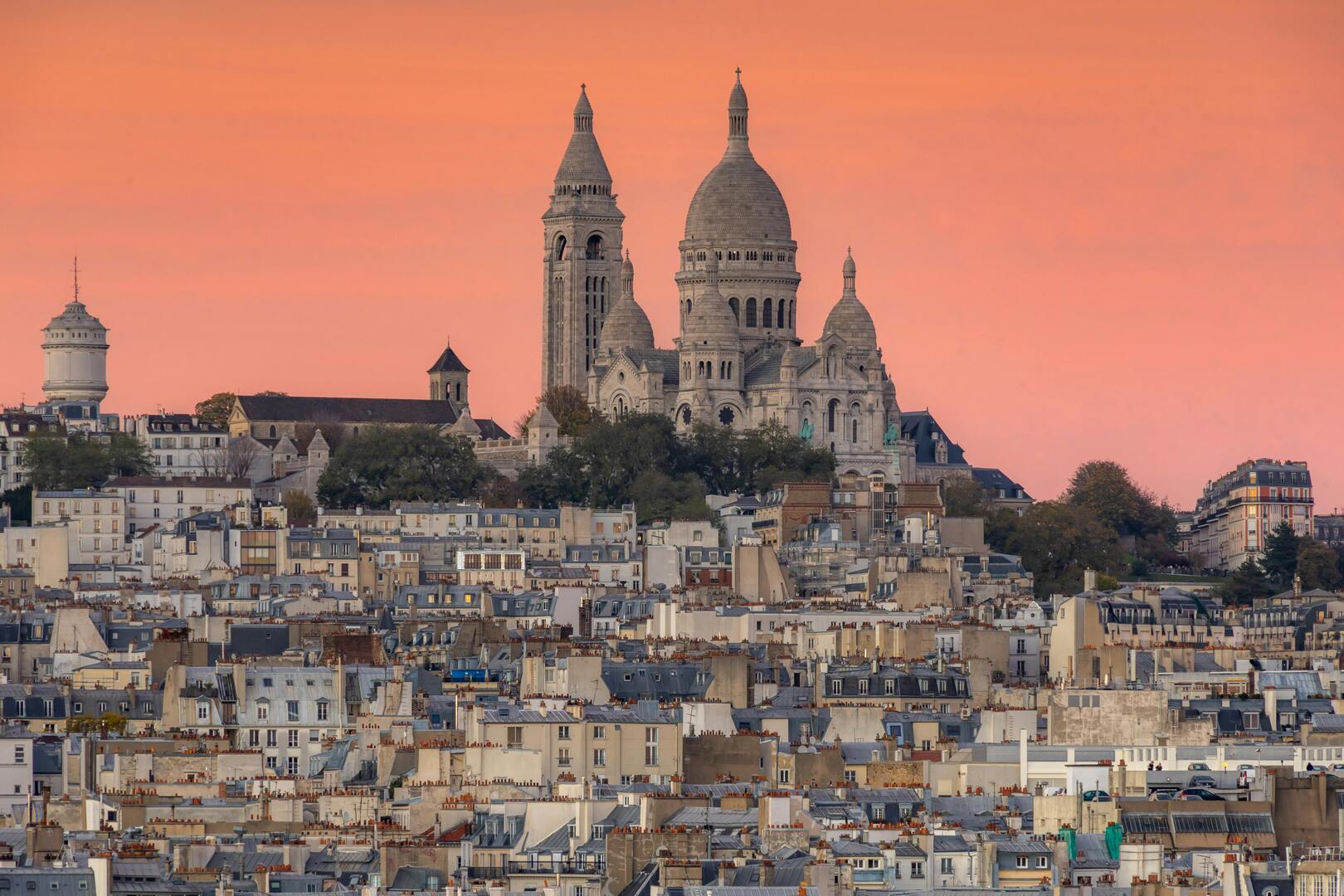 Montmartre hill crowned by Sacré-Cœur Basilica rising above Parisian rooftops