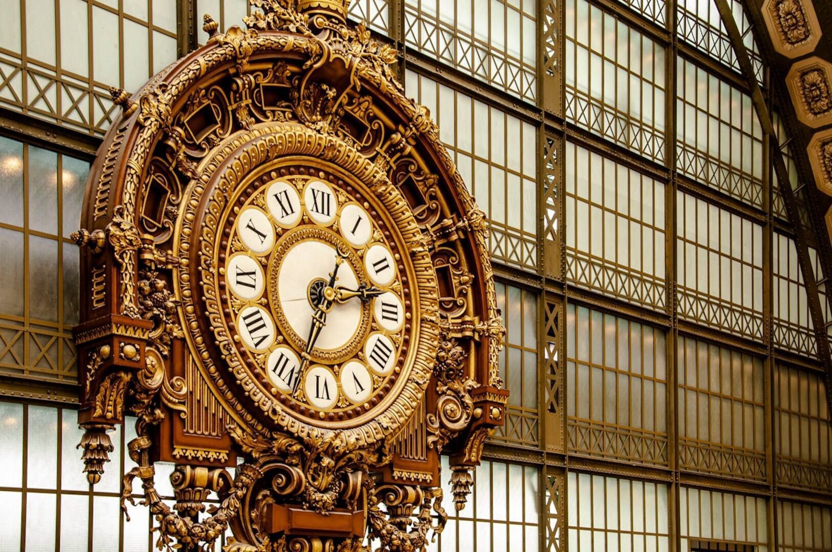 The enormous clock face of the Musée d'Orsay's former railway station facade overlooking the Seine