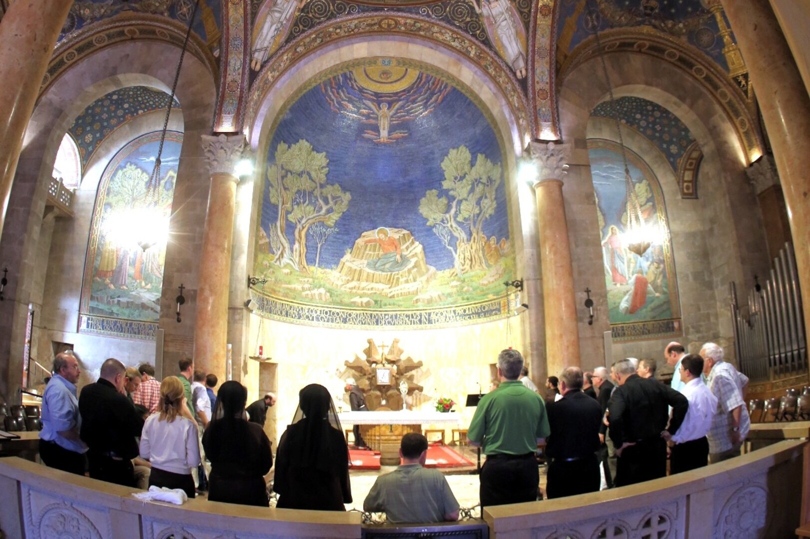 Pilgrims and visitors gathering near Notre-Dame during Holy Week in spring