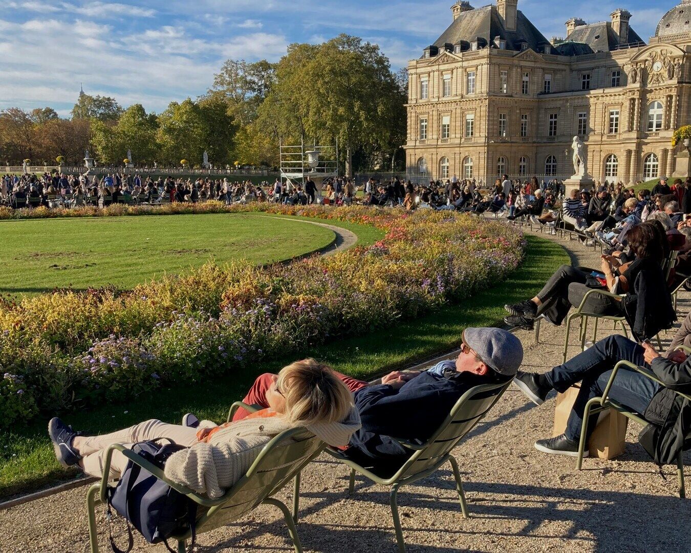 Parisians relaxing in Luxembourg Garden on a warm May afternoon
