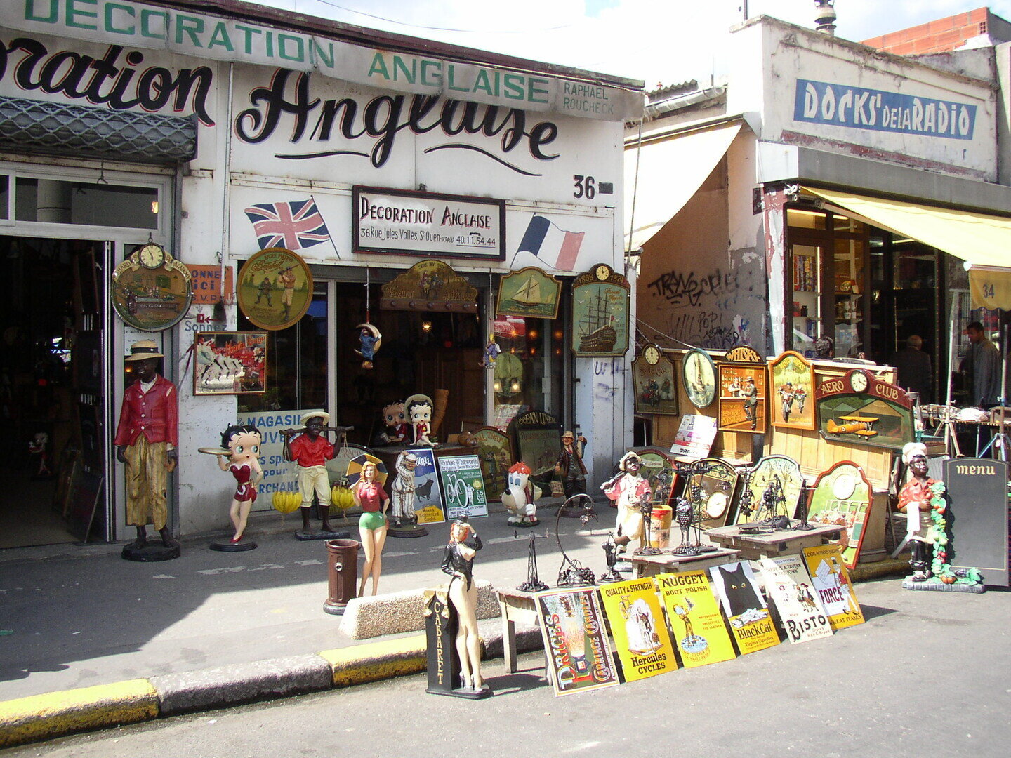 Antiques and vintage stalls at the Saint-Ouen flea market on a bright spring day