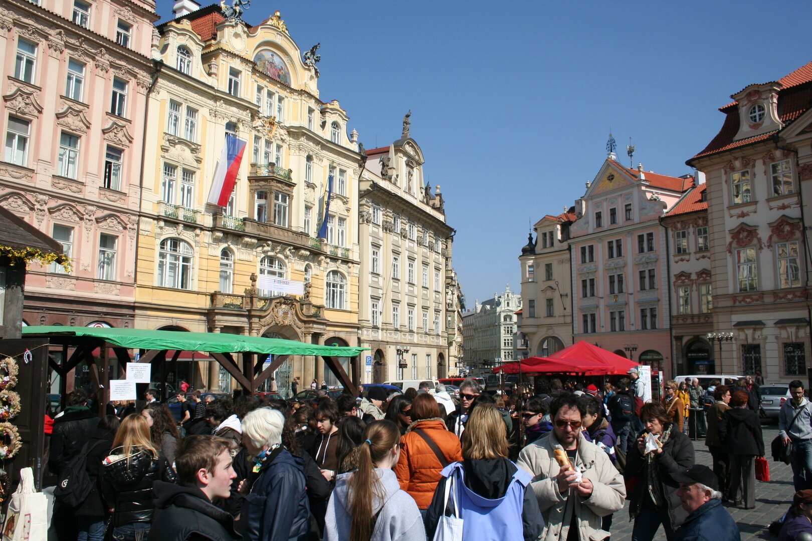 Easter stalls and ribbons in Prague Old Town Square at golden hour