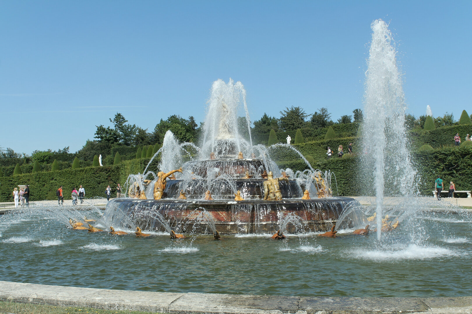 Spring fountain display framed by geometric flower beds at Versailles