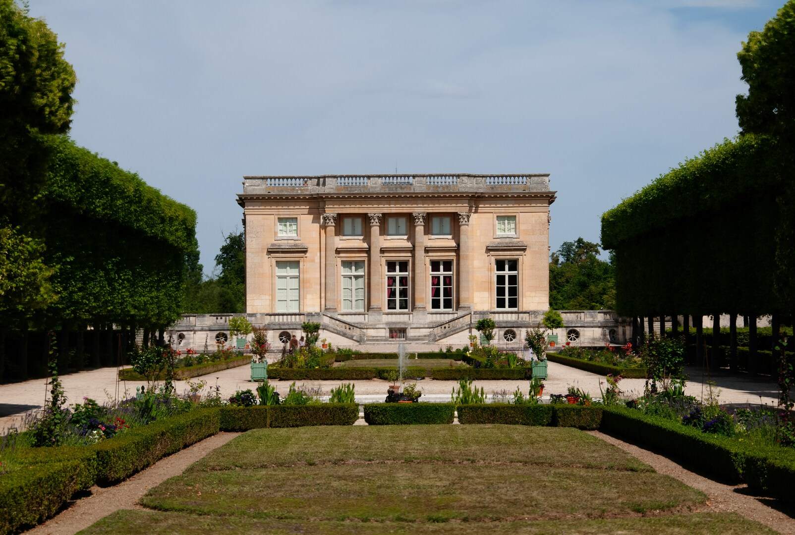 Tree-lined spring pathway near the Trianon estate at Versailles