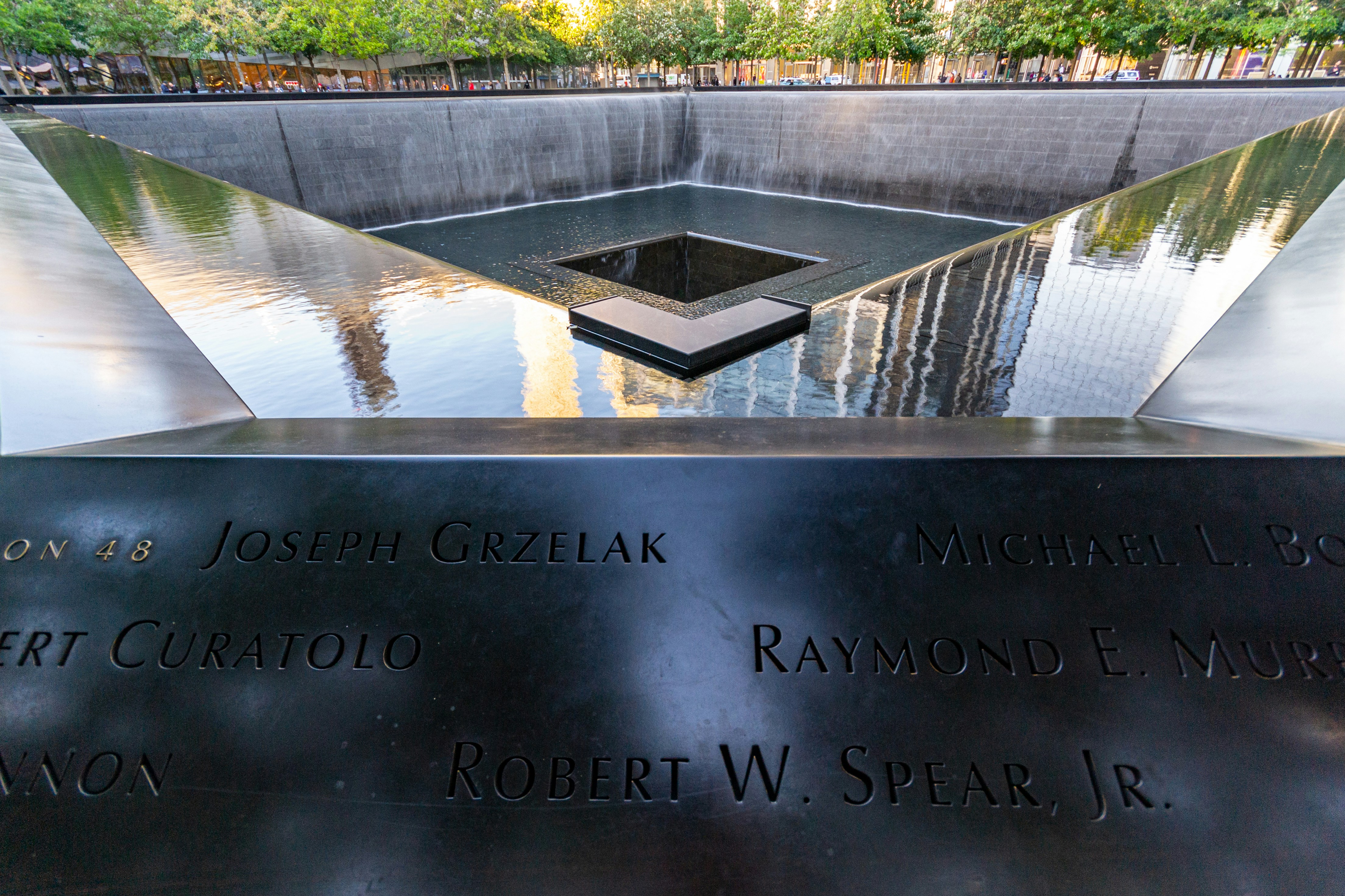 Water falling into the National September 11 Memorial's reflecting pool, with victims' names inscribed on the bronze parapet